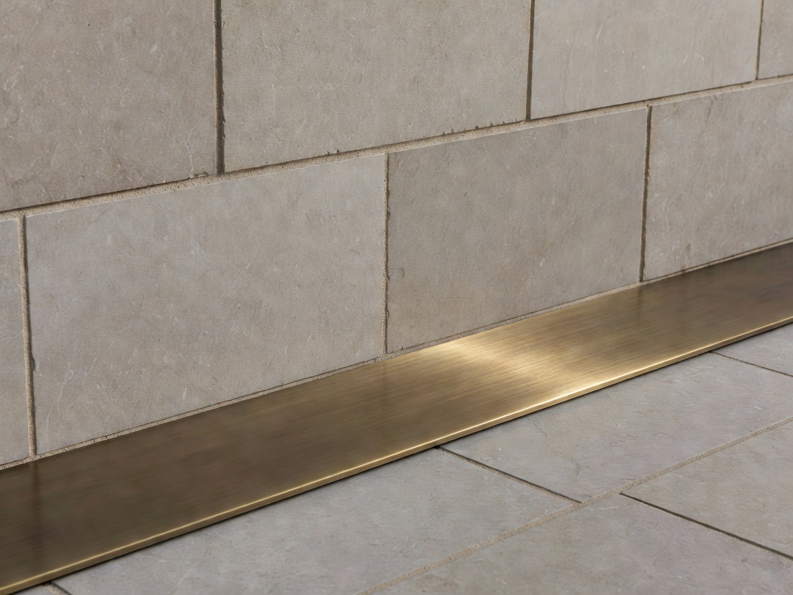 Detail of limestone ashlar jointing and brushed bronze threshold